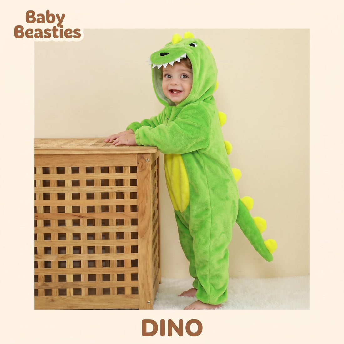 Baby Beasties Green Dinosaur hooded romper worn by a baby